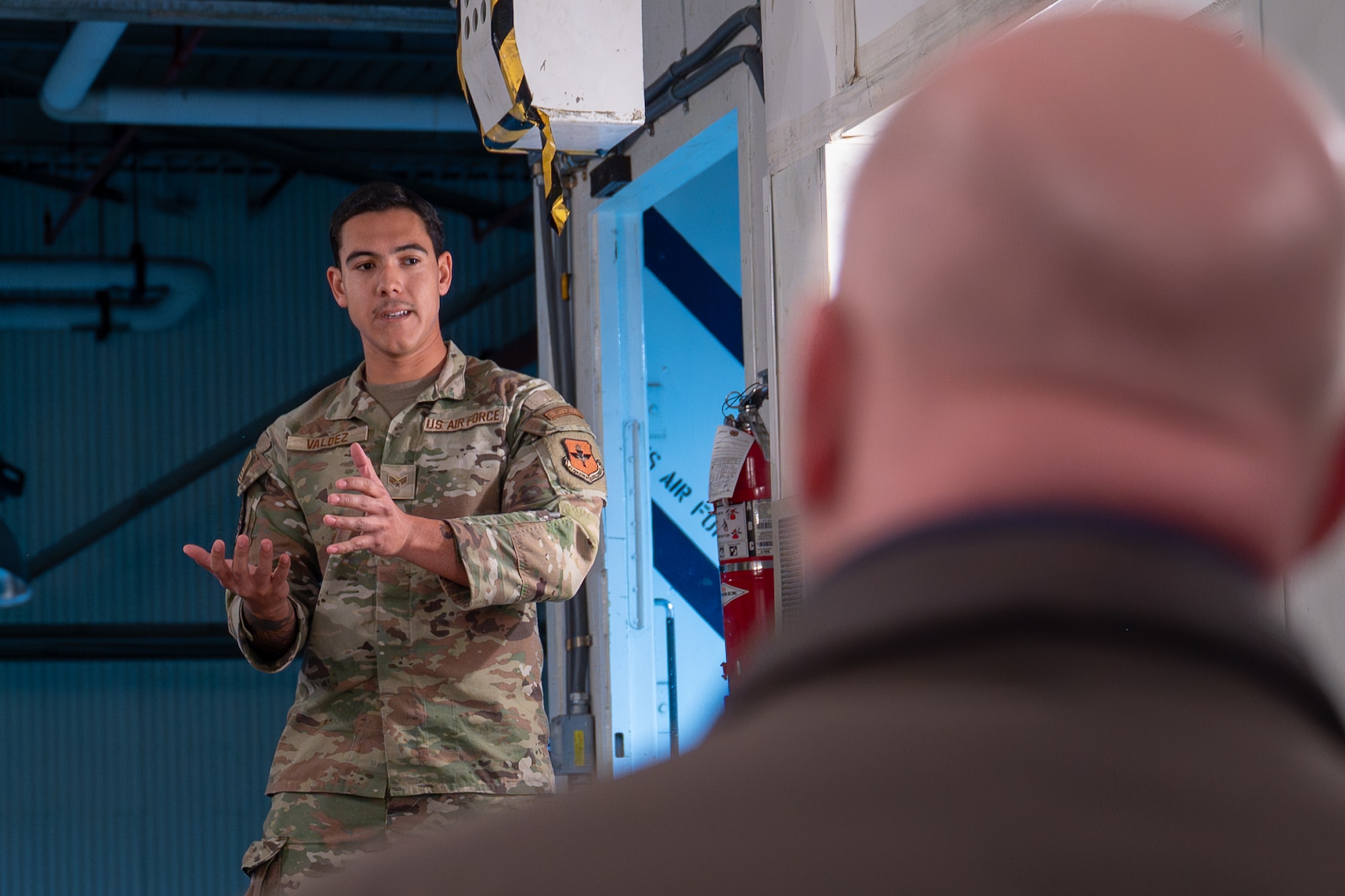 Uniformed personnel speaks to man