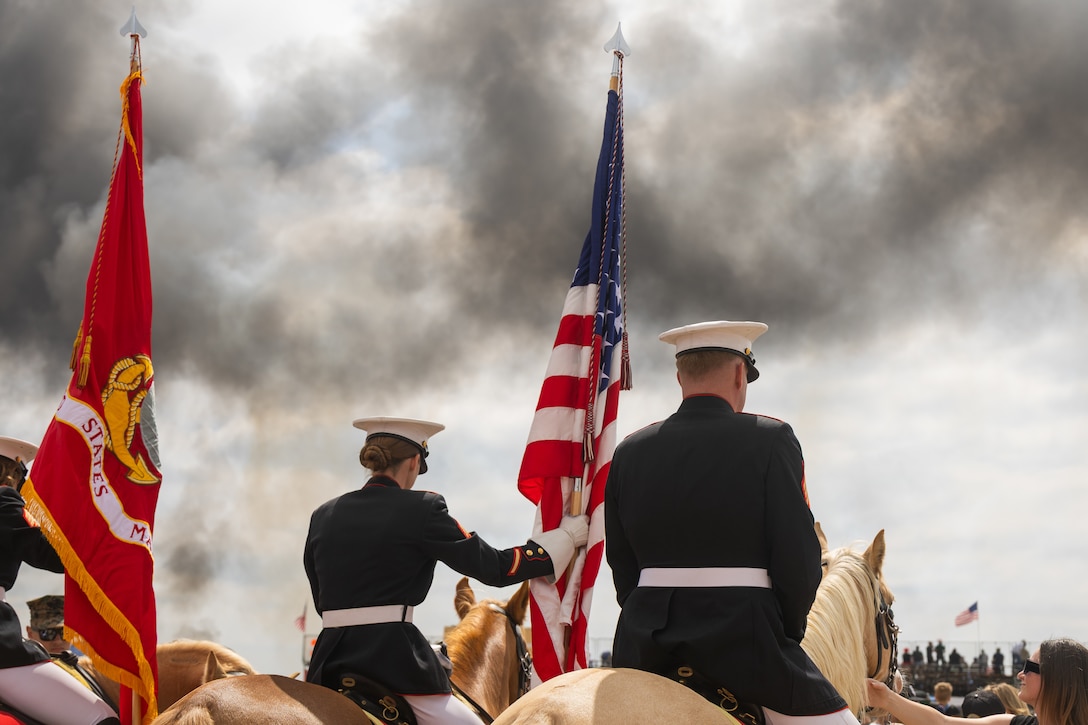 The U.S. Marine Corps Mounted Color Guard presents the national ensign and organizational colors during the 2025 Marine Corps Air Station Miramar Airshow at MCAS Miramar in San Diego, Sept. 27, 2025. The MCAS Miramar Airshow provides a unique flightline experience with static displays and daytime shows that feature military demonstration teams, civilian acrobatic teams, aerial solo acts, vintage aircraft and warbirds. (U.S. Marine Corps photo by Sgt. Bruin Largent)