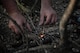 Tech. Sgt. Brett Darby, 5th Operational Support Squadron survival, evade, resistance and escape specialist, shows airmen participating in the combat survival training how to properly start a fire at Garrison, North Dakota, Oct. 9, 2025. Through planning, executing, adapting, and preparing, SERE specialists also help to directly support personnel recovery programs. (U.S. Air Force photo by Senior Airman Alyssa Bankston)