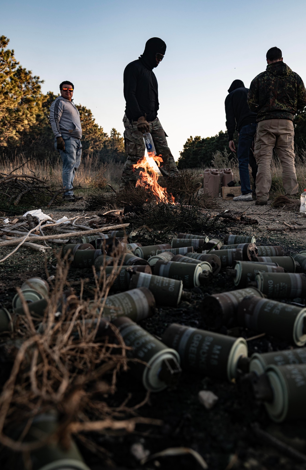 Team Minot Airmen participating in the combat survival training start a fire at Garrison, North Dakota, Oct. 9, 2025. The course went over basic survival skills including wilderness living, shelter construction, fire building, navigation, first aid, signaling and food and water procurement. (U.S. Air Force photo by Senior Airman Alyssa Bankston)