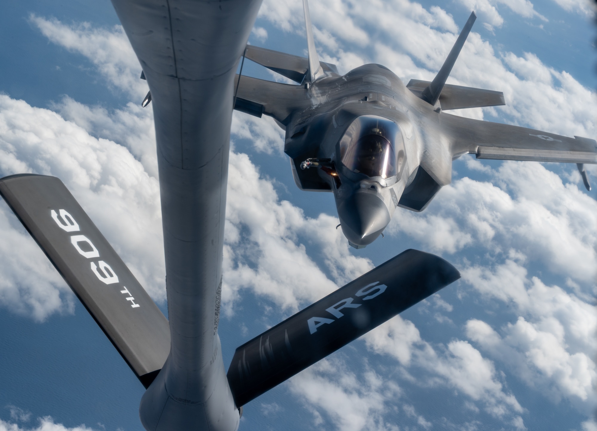 A USMC aircraft approaches a USAF aircraft.