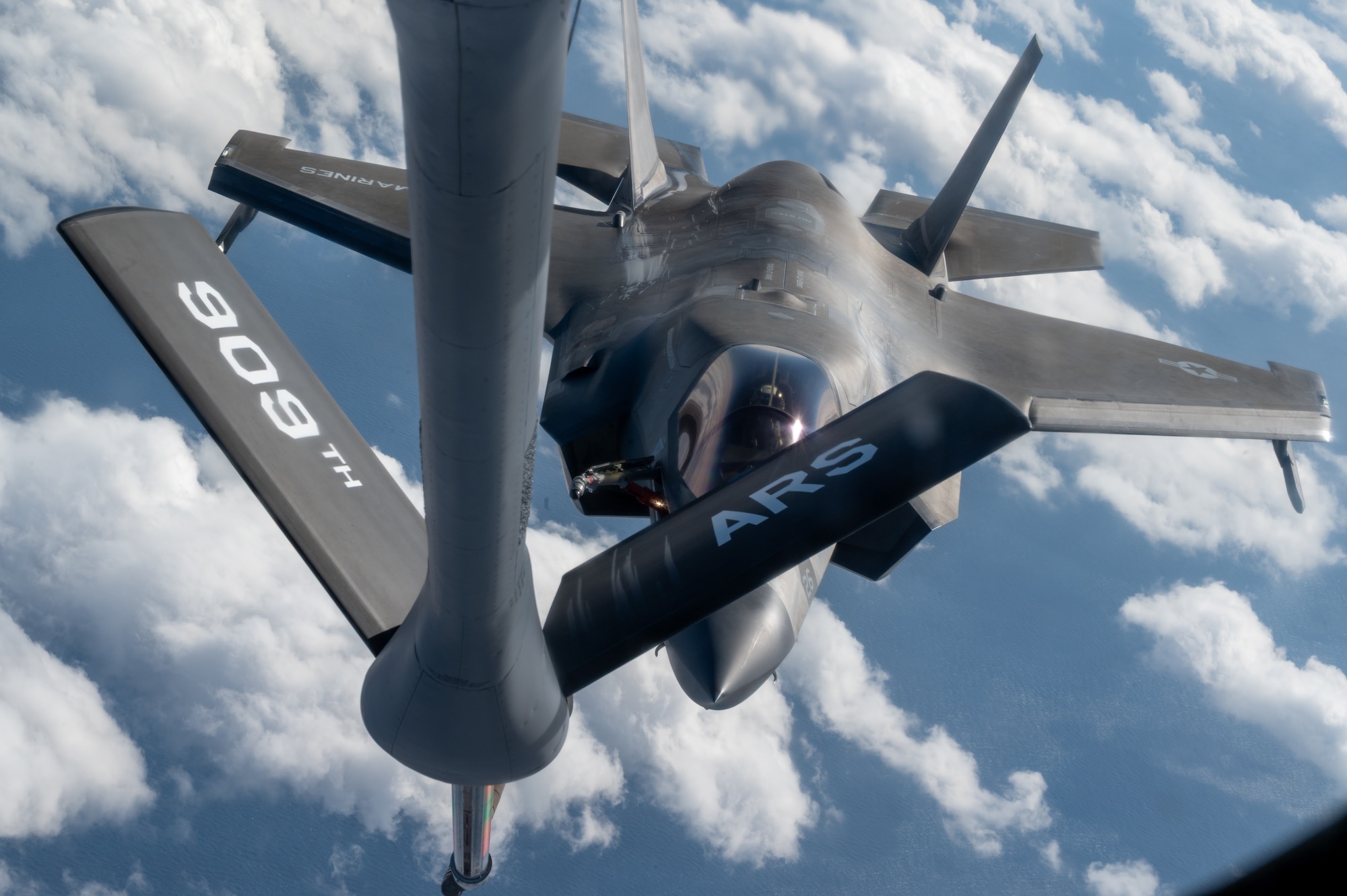A USMC aircraft approaches a USAF aircraft.