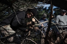 Team Minot Airmen build shelter during combat survival training at Garrison, North Dakota, Oct. 9, 2025. Aircrew members must complete survival, evade, resistance and escape training to prepare for potential hostile situations. (U.S. Air Force photo by Senior Airman Alyssa Bankston)