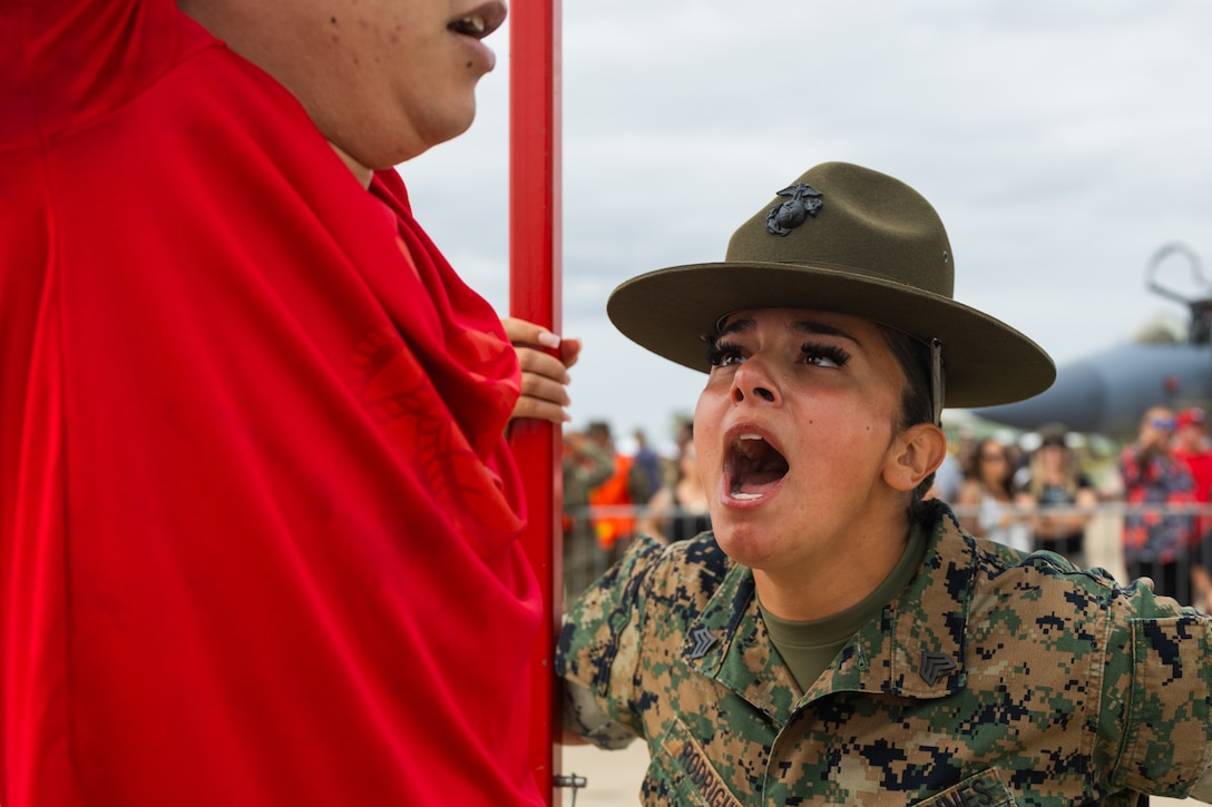 U.S. Marine Corps Sgt. Amanda Rodriguez, a drill instructor with Hotel Company, 2nd Battalion, Marine Corps Recruit Depot San Diego, encourages a poolee during the 2025 Marine Corps Air Station Miramar Airshow at MCAS Miramar in San Diego, California, Sept. 28, 2025. The MCAS Miramar Airshow provides a unique flightline experience with static displays and daytime shows that feature military demonstration teams, civilian acrobatic teams, aerial solo acts, vintage aircraft and warbirds. (U.S. Marine Corps photo by Sgt. Bruin Largent)