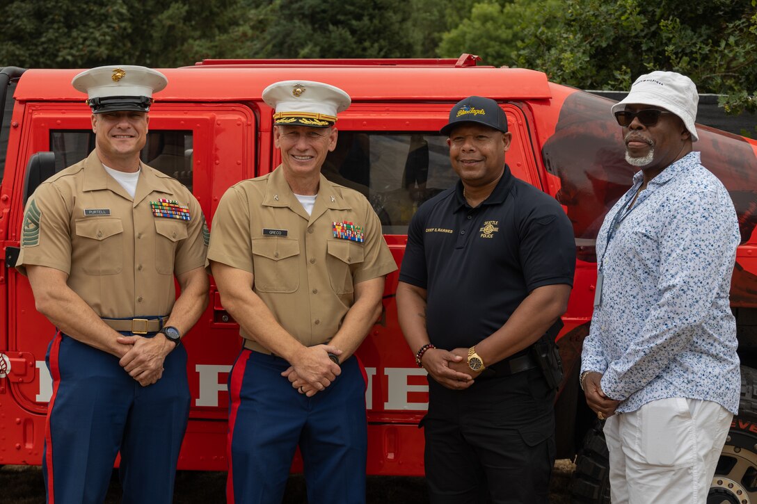 U.S. Marine Corps Col. Jerome Greco, left center, commanding officer for 12th Marine Corps District, and Sgt. Maj. Nicholas Purtell, left, sergeant major for 12th Marine Corps District, pose for a photograph during Seattle Seafair August 2, 2025. Seattle Seafair is a time-honored celebration of the sea services and provides an opportunity for the citizens of Washington to meet Sailors, Marines and Coast Guardsmen, as well as witness firsthand the latest capabilities of today's maritime services. (U.S. Marine Corps photo by Sgt. Bruin Largent)
