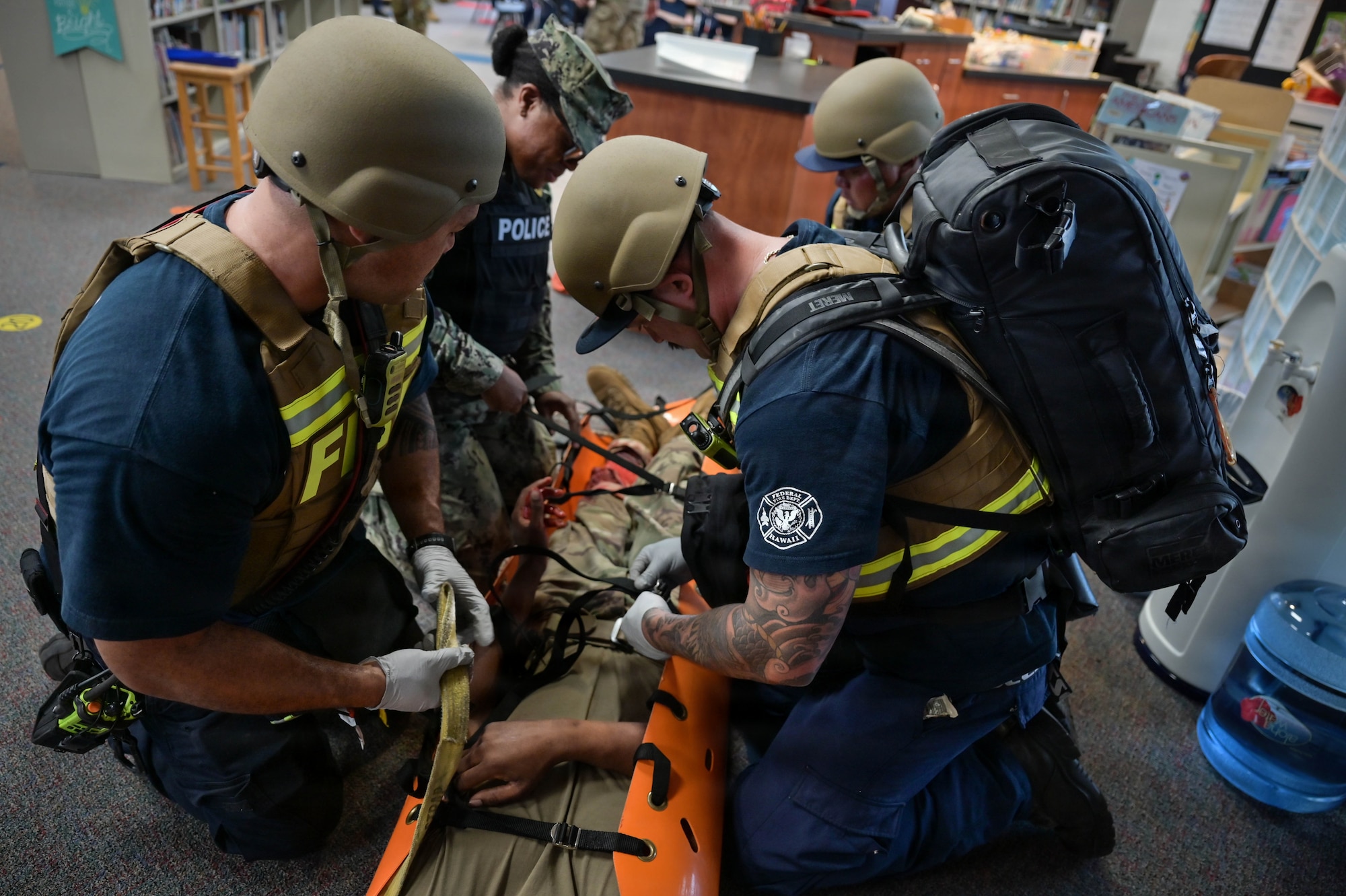Firefighters ready a simulated patient for movement during an exercise.