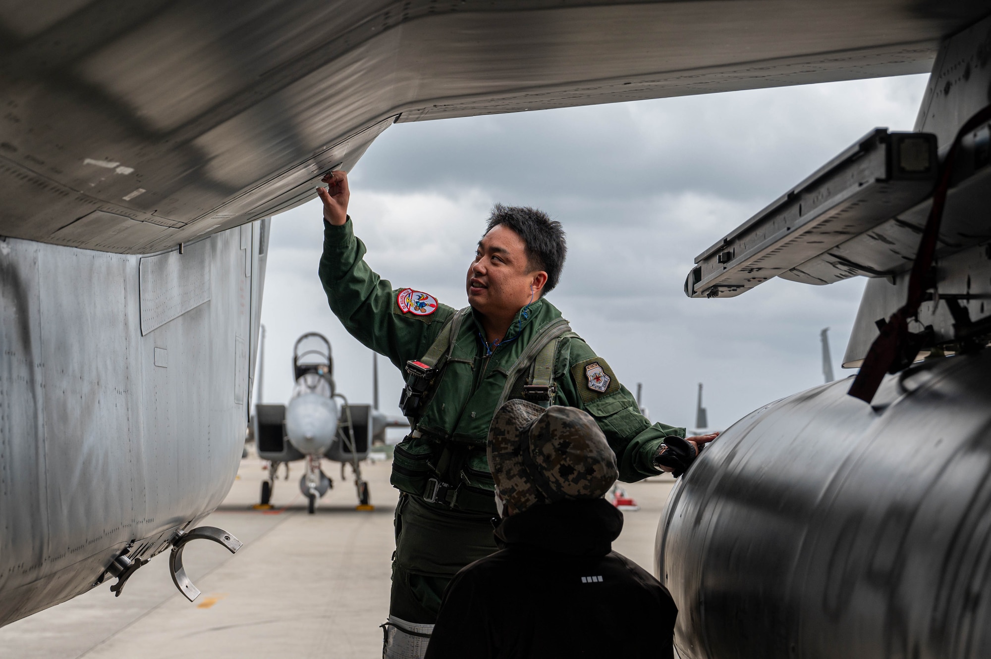 Japan Air Self-Defense Force Maj. Nagamine, performs preflight checks on a F-15DJ Eagle assigned to the 204th Fighter Squadron, at Naha Air Base, Japan, Nov. 19, 2025. Pilots conduct these checks to ensure the aircraft is safe, functional, and ready for flight before taking off. (U.S. Air Force photo by Airman Nathaniel Jackson)