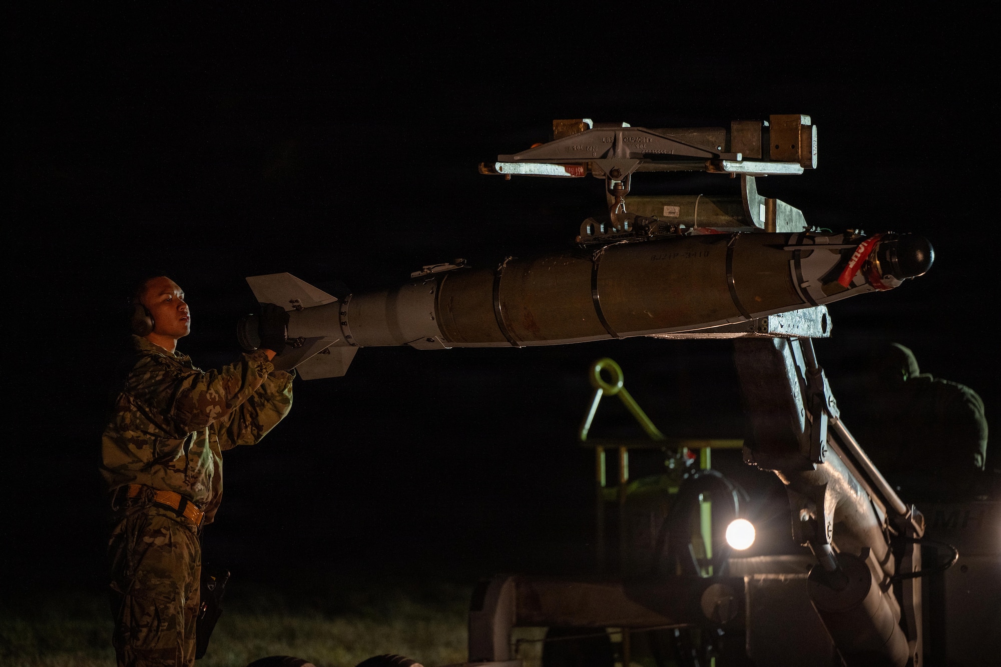Weapons sit on the flightline before being loaded onto a B-1B Lancer