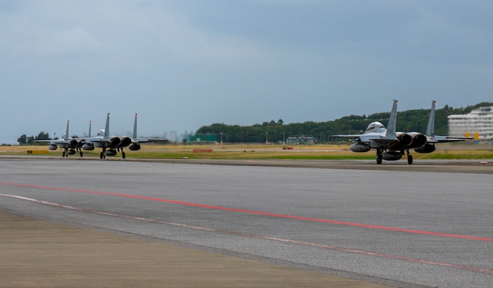Three Japan Air Self-Defense Force F-15J Eagles assigned to the 204th Fighter Squadron, taxi on the runway for a bilateral training mission with the U.S. Air Force at Naha Air Base, Japan, Nov. 19, 2025. The mission supported ongoing efforts to strengthen bilateral capability and maintain stability across the Indo-Pacific. (U.S. Air Force photo by Airman Nathaniel Jackson)