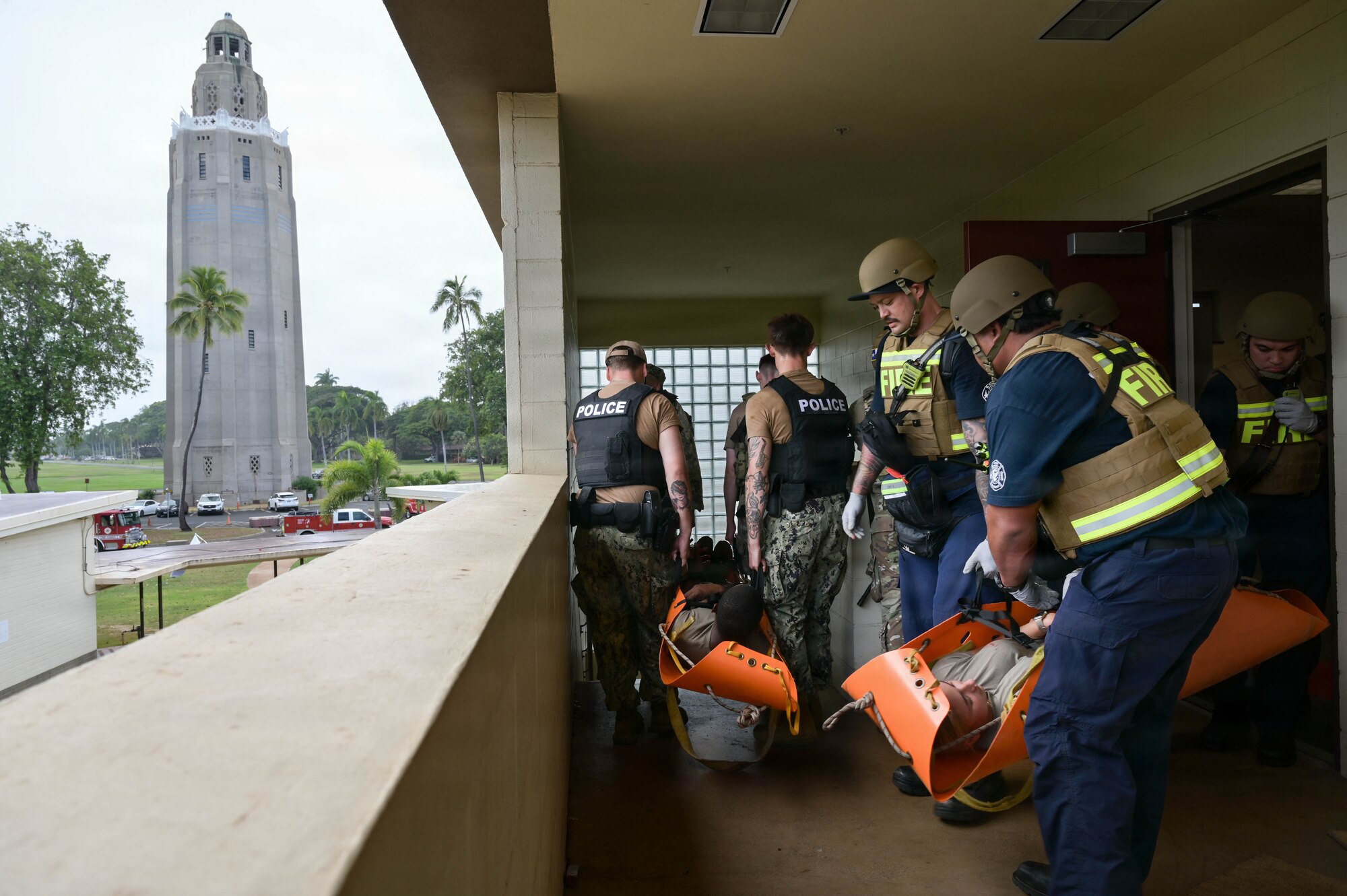 Firefighters carry simulated patients downstairs during an exercise.