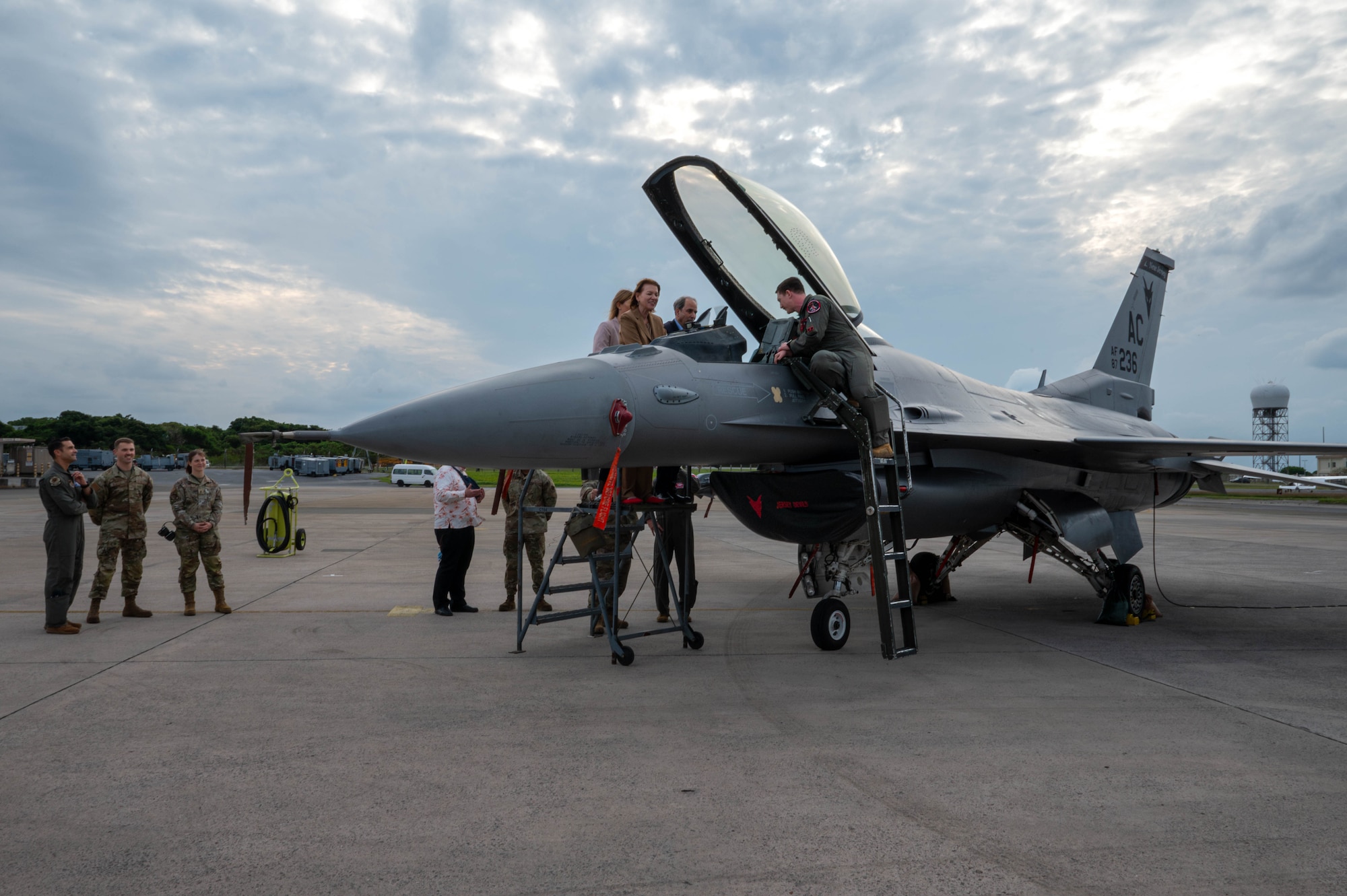 U.S. Air Force Capt. Richard DePaola, 119th Expeditionary Fighter Squadron fighter F-16C pilot deployed to Kadena, briefs Petra Sigmund, Director General for East Asia, Southeast Asia and the Pacific at the Federal Foreign Office, on the Fighting Falcon cockpit setup during a familiarization tour at Kadena Air Base, Japan, Nov. 21, 2025. The visit gave Sigmund and her team a firsthand look at Kadena’s mission and the Airmen driving operations in the Indo-Pacific. (U.S. Air Force photo by Airman Nathaniel Jackson)