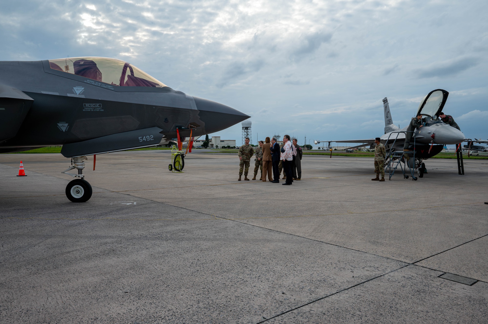 U.S. Air Force Brig. Gen. John Gallemore, 18th Wing commander, briefs Petra Sigmund, Director General for East Asia, Southeast Asia and the Pacific at the Federal Foreign Office, while touring the flight line during a familiarization tour at Kadena Air Base, Japan, Nov. 21, 2025. The visit offered an opportunity to see how Kadena’s capabilities integrate with allied efforts across the Indo-Pacific. (U.S. Air Force photo by Airman Nathaniel Jackson)