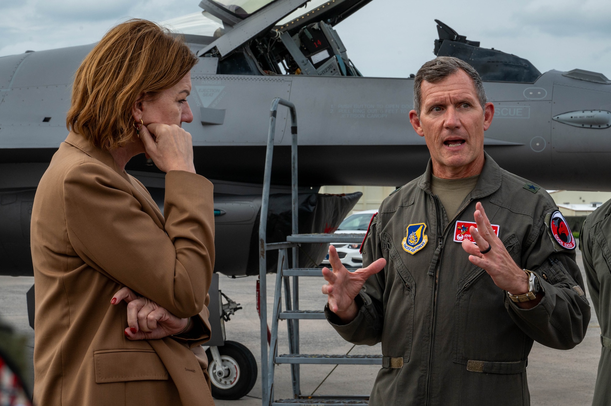 U.S. Air Force Brig. Gen. John Gallemore, right, 18th Wing commander, briefs Petra Sigmund, Director General for East Asia, Southeast Asia and the Pacific at the Federal Foreign Office, while touring the flight line during a familiarization tour at Kadena Air Base, Japan, Nov. 21, 2025. The visit gave Petra and her team a firsthand look at Kadena’s mission and the Airmen driving operations in the Indo-Pacific. (U.S. Air Force photo by Airman Nathaniel Jackson)