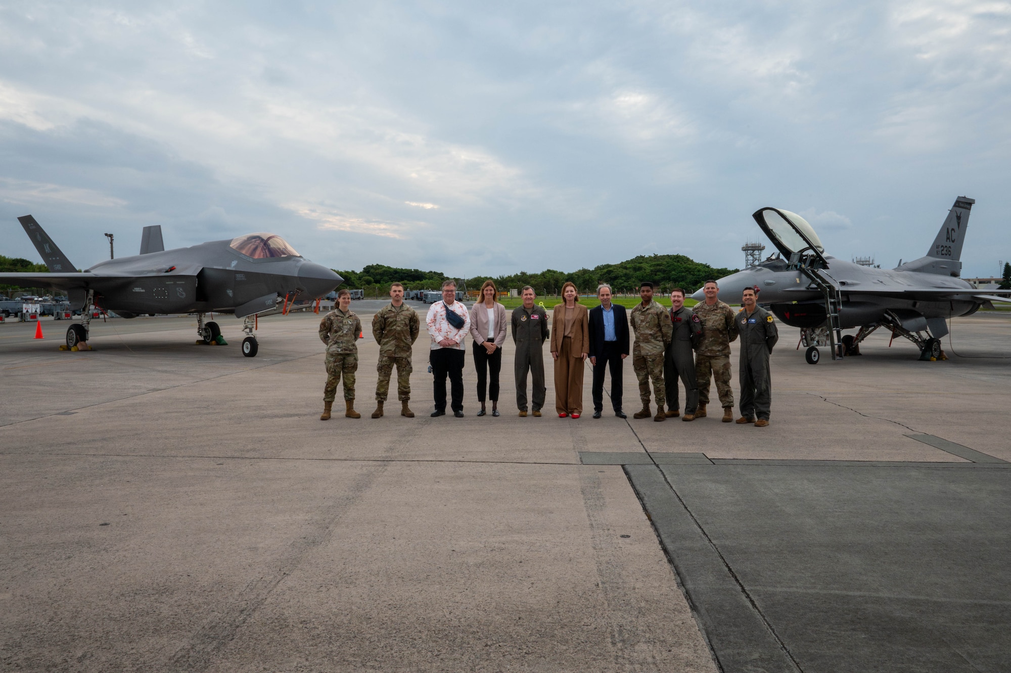 U.S. Air Force Brig. Gen. John Gallemore, middle, 18th Wing commander, poses with Petra Sigmund,Director General for East Asia, Southeast Asia and the Pacific at the Federal Foreign Office, her team, and maintenance Airmen after touring the flight line during a familiarization tour at Kadena Air Base, Japan, Nov. 21, 2025. Visits like this strengthen allied partnerships and highlight the 18th Wing’s role in supporting operations across the Indo-Pacific. (U.S. Air Force photo by Airman Nathaniel Jackson)