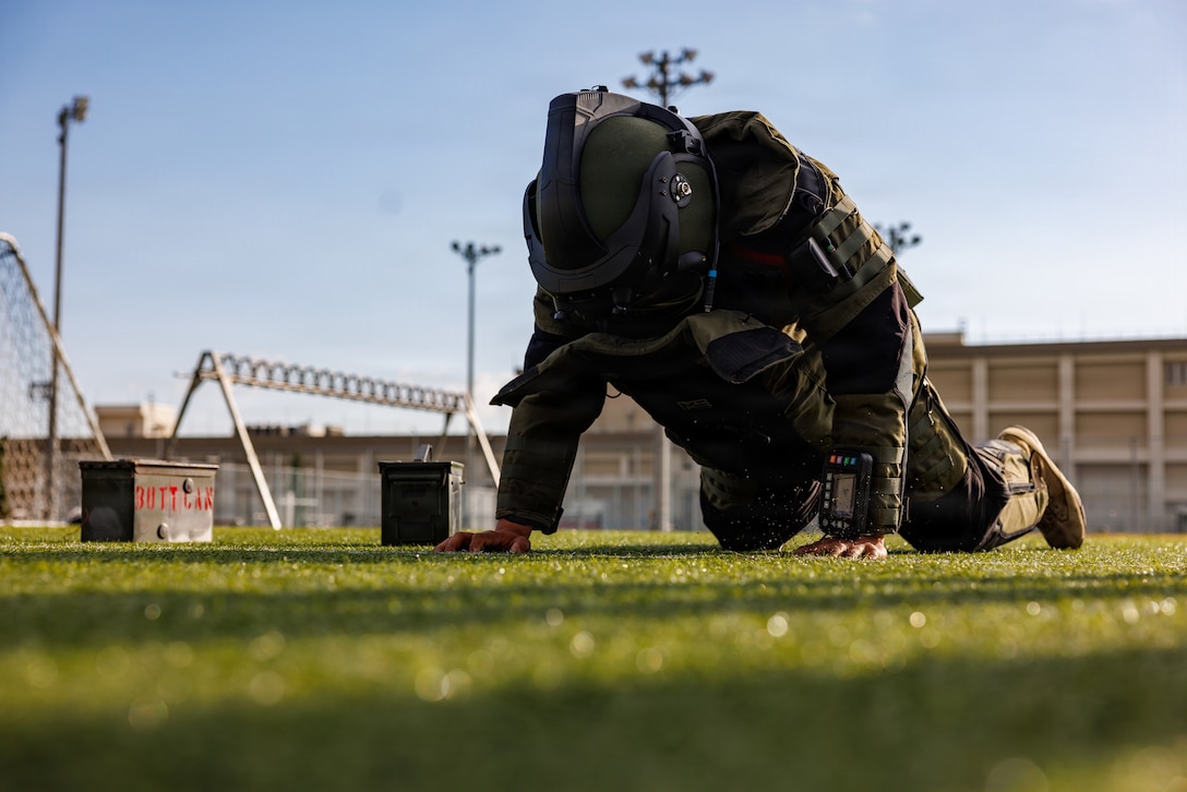 U.S. Marine Corps Cpl. Orion Chamness, an engineer equipment operator for Marine Wing Support Squadron 171, Marine Aircraft Group 12, 1st Marine Aircraft Wing, and a native of Orange Park, Florida, conducts the explosive ordnance disposal bomb suit agility test during an EOD screening test at Marine Corps Air Station Iwakuni, Japan, Nov. 19, 2025. EOD conducted this screening to identify and evaluate potential applicants attempting to lateral migrate into their military occupational specialty. (U.S. Marine Corps photo by Cpl. Dahkareo Pritchett)
