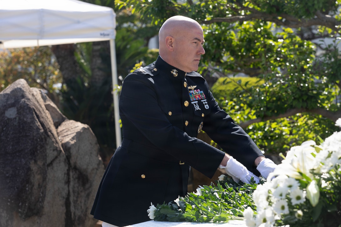 U.S. Marine Corps Col. Kenneth Rossman, the commanding officer of Marine Corps Air Station Iwakuni, and native of Pittsburgh, Pennsylvania, places a flower on a memorial site during a memorial service at MCAS Iwakuni, Japan, Nov. 07, 2025. Japan Maritime Self-Defense Force Fleet Air Wing 31 held an annual memorial ceremony to honor fallen JMSDF sailors who dedicated their lives to protecting Japan. (U.S. Marine Corps photo by Lance Cpl. Siwan Lewis)