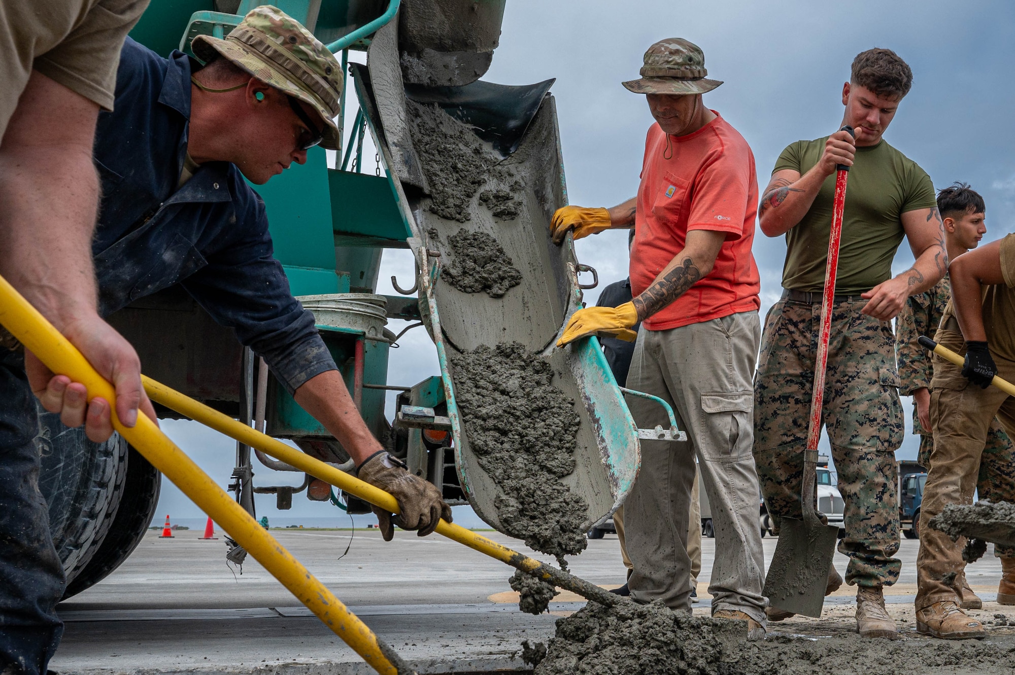 A concrete truck delivers wet concrete to U.S. military service members assigned to Kadena Air Base during a full-depth pavement repair Nov. 14, 2025. As the keystone of the Pacific, Kadena's strategic location makes it a pivotal installation for ensuring the defense of Japan and a free and open Indo-Pacific. (U.S. Air Force photo by Airman Nathaniel Jackson)