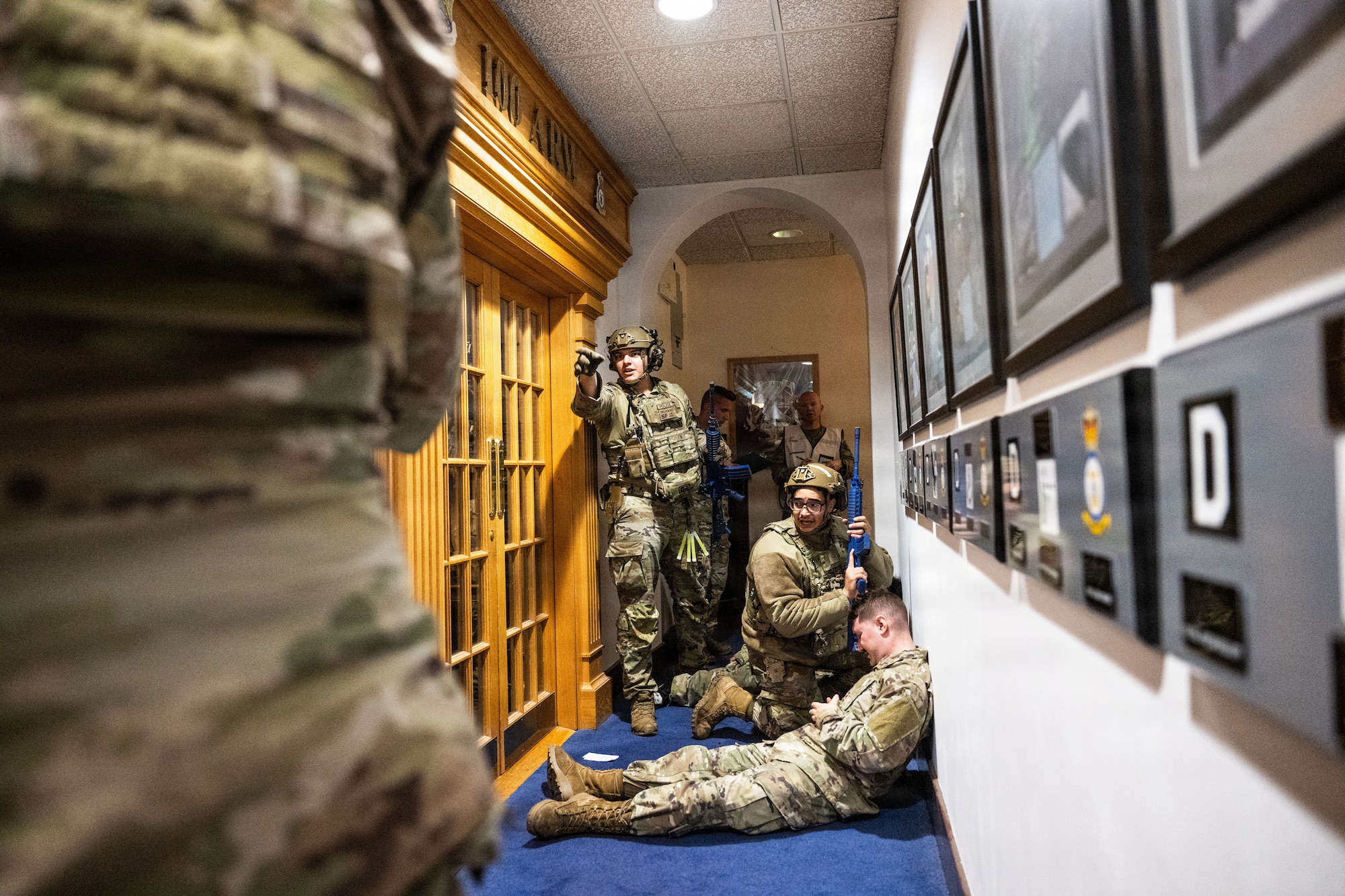 Airmen assigned to the 100th Security Forces Squadron coordinate emergency response efforts during a simulated active shooter exercise at RAF Mildenhall, England, Nov. 13, 2025.