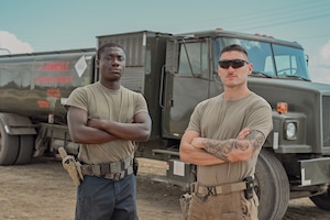 U.S. Air Force Airman 1st Class Kwaku Owusu and Senior Airman Jacob Rosales, 475th Expeditionary Air Base Squadron Vehicle Maintenance section, post in front of a R-11 fuel truck at Camp Simba, Kenya, Nov. 6, 2025.