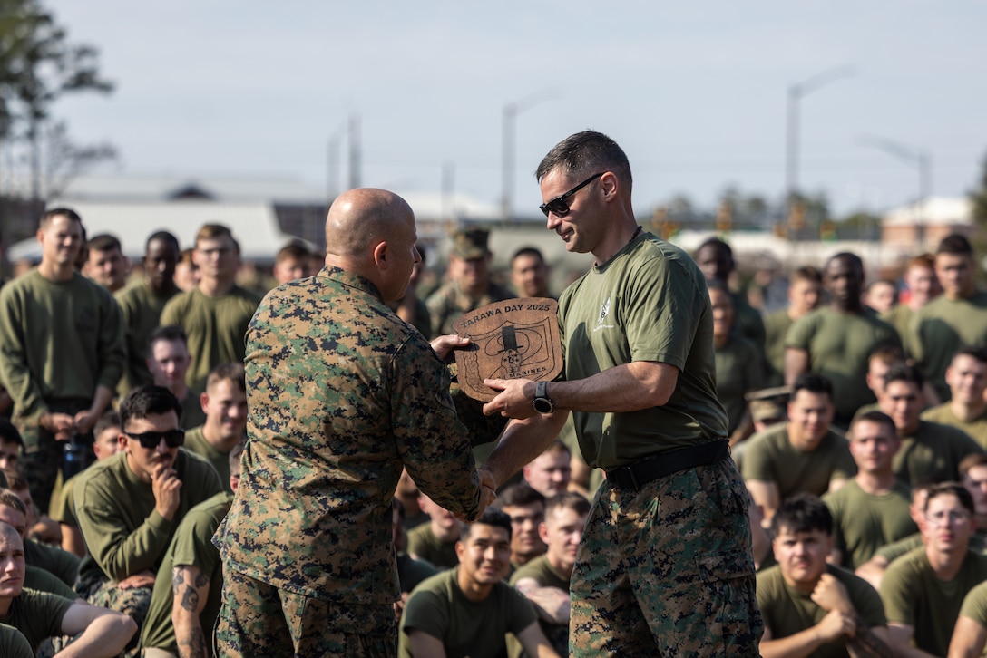 U.S. Marine Corps Major Gen. Farrell J. Sullivan, left, a native of New York and the commanding general of 2nd Marine Division, presents the Tarawa Day plaque to Lt. Col. Matt Wills, a native of Michigan and the commanding officer of 2nd Battalion, 8th Marine Regiment, 2nd Marine Division, during Tarawa Day on Marine Corps Base Camp Lejeune, North Carolina, Nov. 19, 2025. Tarawa Day commemorates the beginning of battle of the Tarawa on Nov. 20, 1943. (U.S. Marine Corps photo by Lance Cpl. Brian Bolin Jr.)