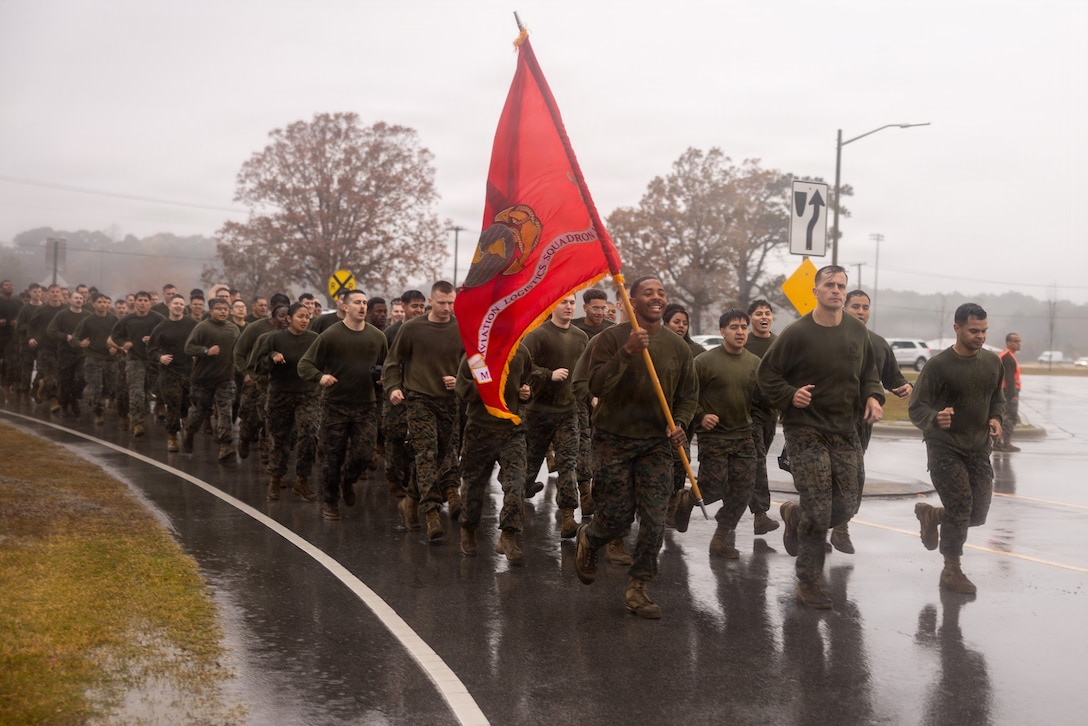 U.S. Marines and Sailors with Marine Aircraft Group (MAG) 14, 2nd Marine Aircraft Wing run in formation after the Cactus Cup at Marine Corps Air Station Cherry Point, North Carolina, Nov. 21, 2025. The Cactus Cup is an annual competition among MAG-14 squadrons that tests the strength of its competitors and strengthens unit morale. (U.S. Marine Corps photo by Staff Sgt. Maximiliano Rosas)