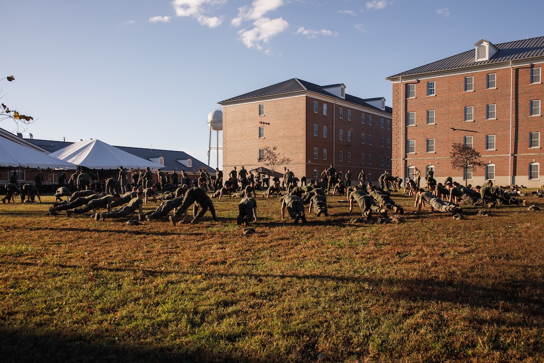U.S. Marines with The Basic School, Training Command, conduct warmups during a field meet at Marine Corps Base Quantico, Virginia, Oct. 31, 2025. During the field meet, Marines with TBS participated in physical training and competitions to build camaraderie and celebrate the Marine Corps' 250th Birthday. (U.S. Marine Corps photo by Cpl. Joshua Barker)