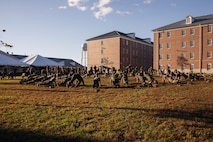 U.S. Marines with The Basic School, Training Command, conduct warmups during a field meet at Marine Corps Base Quantico, Virginia, Oct. 31, 2025. During the field meet, Marines with TBS participated in physical training and competitions to build camaraderie and celebrate the Marine Corps' 250th Birthday. (U.S. Marine Corps photo by Cpl. Joshua Barker)