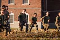 U.S. Marines with The Basic School, Training Command, conduct warmups during a field meet at Marine Corps Base Quantico, Virginia, Oct. 31, 2025. During the field meet, Marines with TBS participated in physical training and competitions to build camaraderie and celebrate the Marine Corps' 250th Birthday. (U.S. Marine Corps photo by Cpl. Joshua Barker)