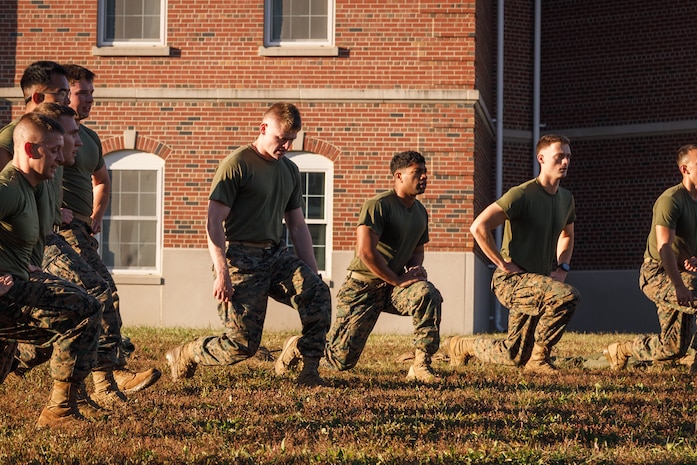 U.S. Marines with The Basic School, Training Command, conduct warmups during a field meet at Marine Corps Base Quantico, Virginia, Oct. 31, 2025. During the field meet, Marines with TBS participated in physical training and competitions to build camaraderie and celebrate the Marine Corps' 250th Birthday. (U.S. Marine Corps photo by Cpl. Joshua Barker)