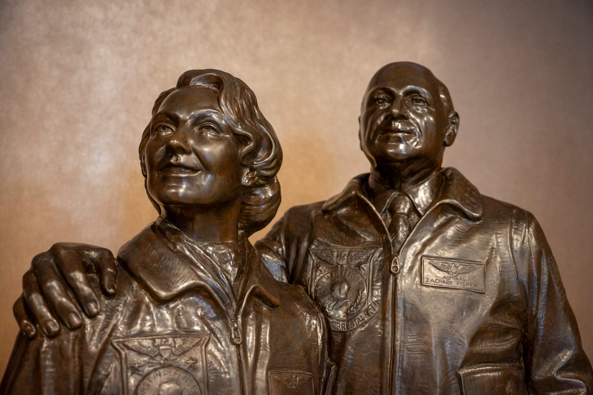 A bronze statue of Zachary and Elizabeth Fisher, Founders of the Fisher House Foundation, displayed inside of the Dover Fisher House for Families of the Fallen, Dover Air Force Base, Delaware, Nov. 18 2025. Identified by the Fisher Foundation as a complement to the Center for Families of the Fallen, the Fisher House for Families of the Fallen is the 50th house within the Fisher family of homes. The House was gifted to the Air Force and dedicated Nov. 10, 2010. (U.S. Air Force photo by Staff Sgt. Frank Rohrig)