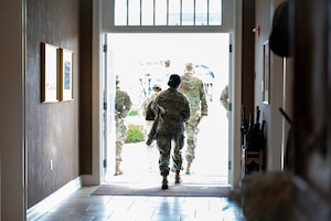 U.S. Air Force Capt. Tamikka Williams, Air Force Mortuary Affairs Operations operations division chief, departs the Dover Fisher House for Families of the Fallen, Dover Air Force Base, Delaware, Nov. 18, 2025. The Fisher House for Families of the Fallen at Dover Air Force Base, Delaware, is a unique facility among the Fisher House Foundation's other locations. It is the only one of its kind, designed for families of the fallen and managed exclusively by uniformed personnel. It is designed to provide short-term, on-base lodging to families who travel to Dover AFB to witness the dignified transfer of their loved one. (U.S. Air Force photo by Staff Sgt. Frank Rohrig)