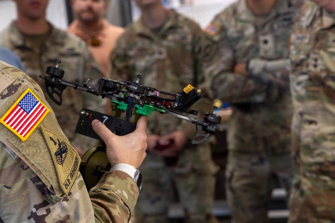 A closeup of a soldier holding a drone.