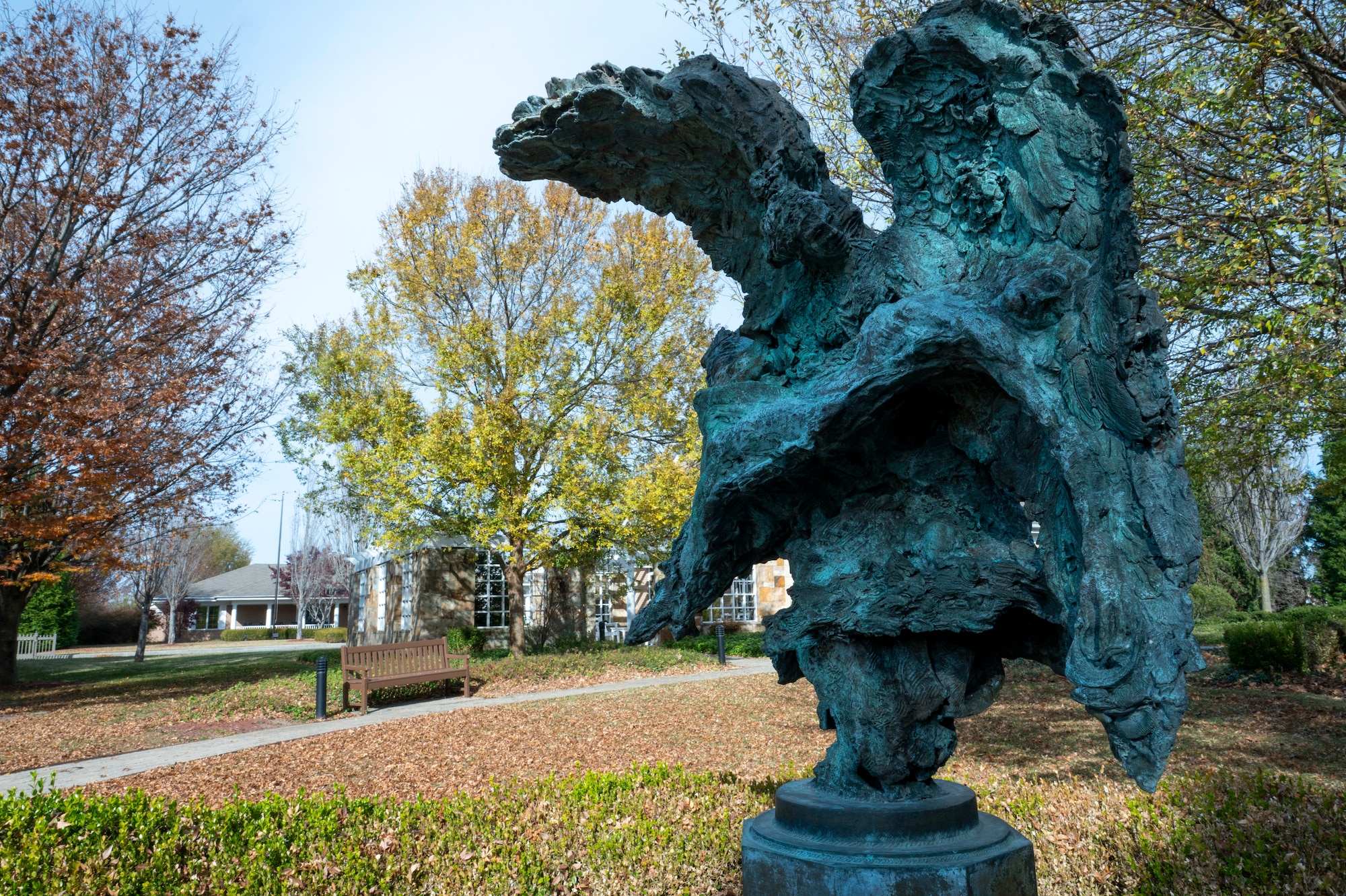 A bronze statue titled “Angel and the Dying Unknown” stands on display outside the meditation pavilion as part of The Campus for the Families of the Fallen, Dover Air Force Base, Delaware, Nov. 18, 2025. Adjacent to the Fisher House for Families of the Fallen is a Meditation Pavilion. The 1,714 square foot Meditation Pavilion provides a quiet place for families to gather, pray and reflect during their stay at the Fisher House. The pavilion is used as a gathering place for families, and is the first and only one of its kind. (U.S. Air Force photo by Staff Sgt. Frank Rohrig)