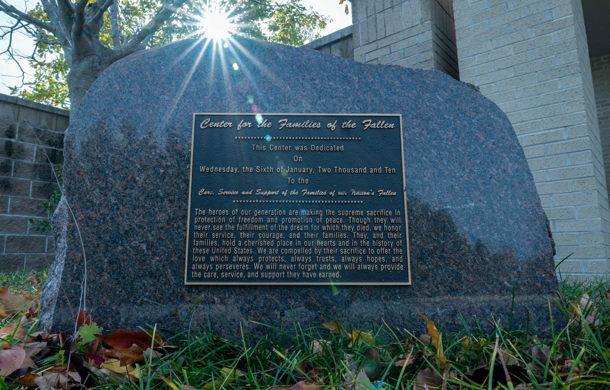A plaque outside of the Center for the Families of the Fallen marks the date the building was established and provides a short inscription, Dover Air Force Base, Delaware, Nov. 18, 2025. The plaque writes ” The heroes of our generation are making the supreme sacrifice in protection of freedom and promotion of peace. Though they will never see the fulfillment of the dream for which they died, we honor their service, their courage, and their families. They, and their families, hold a cherished place in our hearts and in the history of these United States. We are compelled by their sacrifice to offer the love which always protects, always trusts, always hopes, and always perseveres. We will never forget and we will always provide the care, service, and support they have earned.”  (U.S. Air Force photo by Staff Sgt. Frank Rohrig)