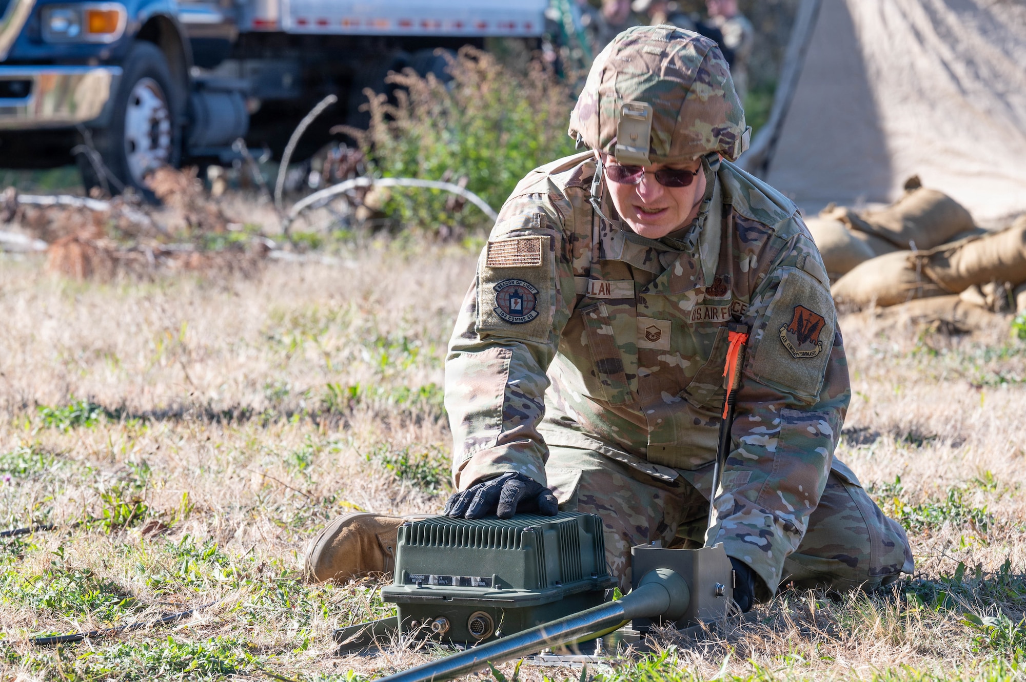 Photo of an Airman working on a piece of communications equipment.