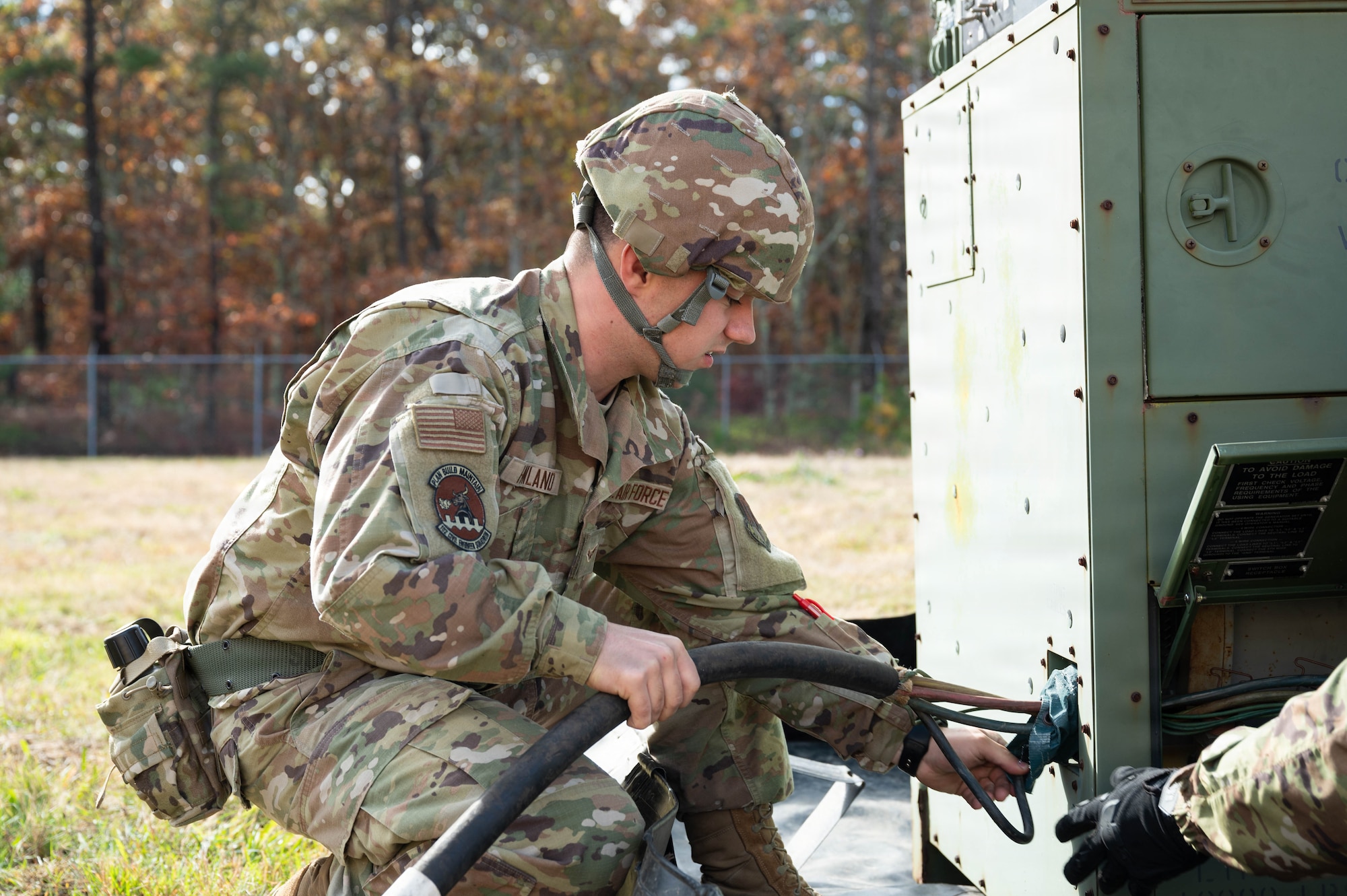Photo of an Airman performing maintenance on a generator.