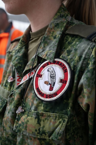 Photo of Royal Netherlands Air Force and RAF Lakenheath members looking at F-35A Lightning II aircraft.