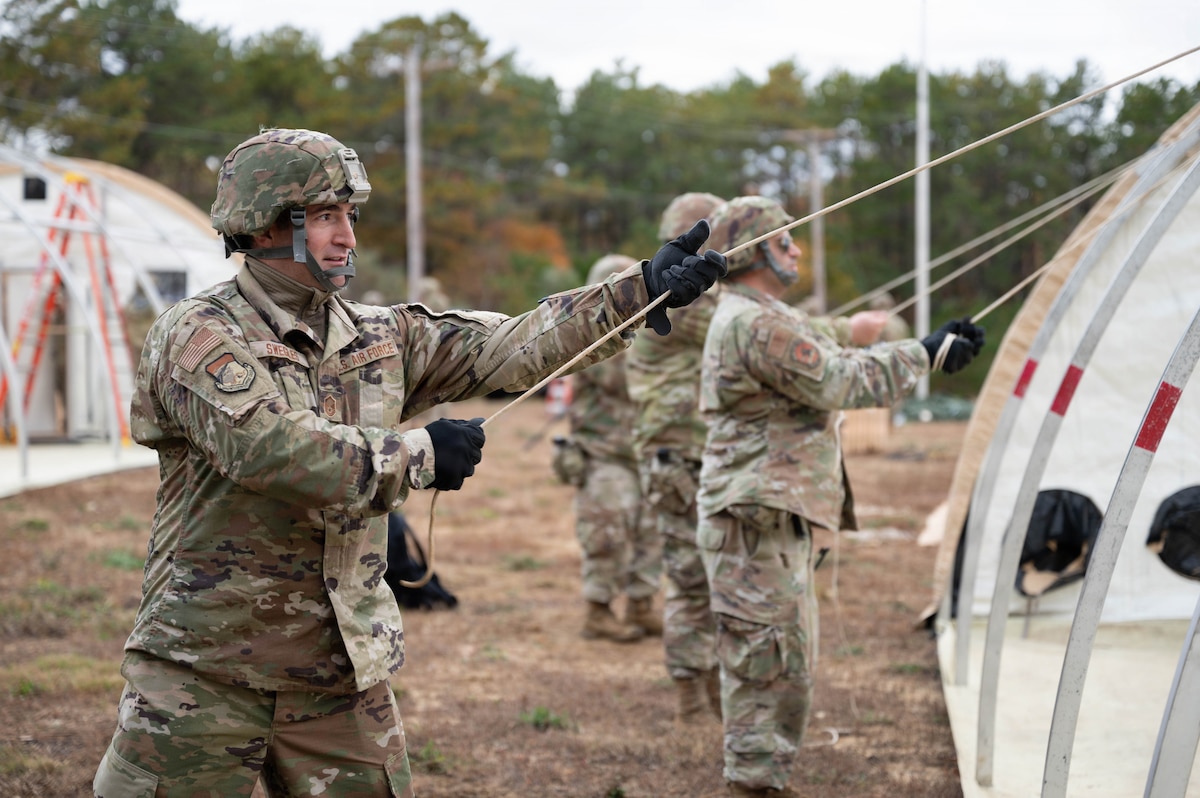 Photo of an Airman building a tent.