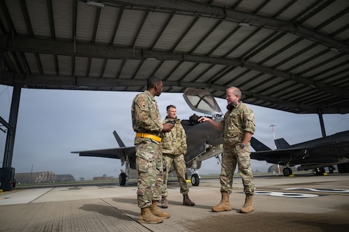Photo of Royal Netherlands Air Force and RAF Lakenheath members looking at F-35A Lightning II aircraft.