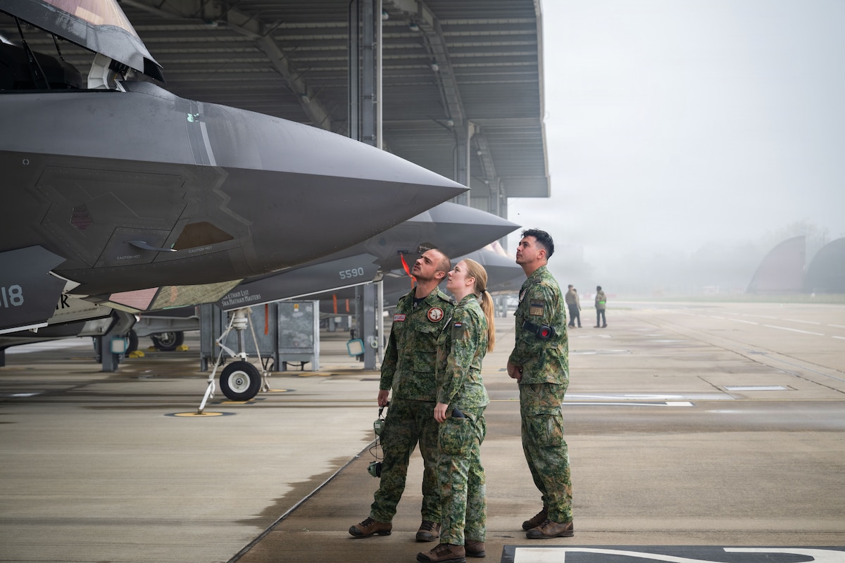 Photo of Royal Netherlands Air Force and RAF Lakenheath members looking at F-35A Lightning II aircraft.