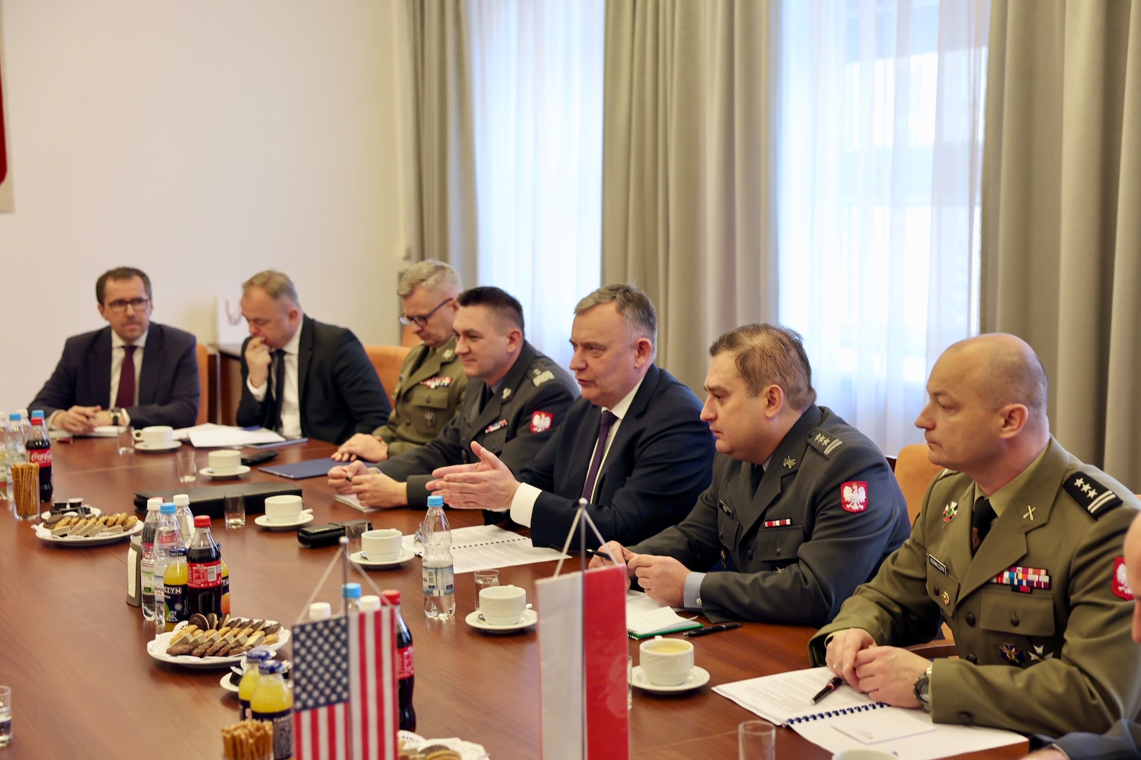 A group of people sit at conference table.