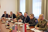 A group of people sit at conference table.