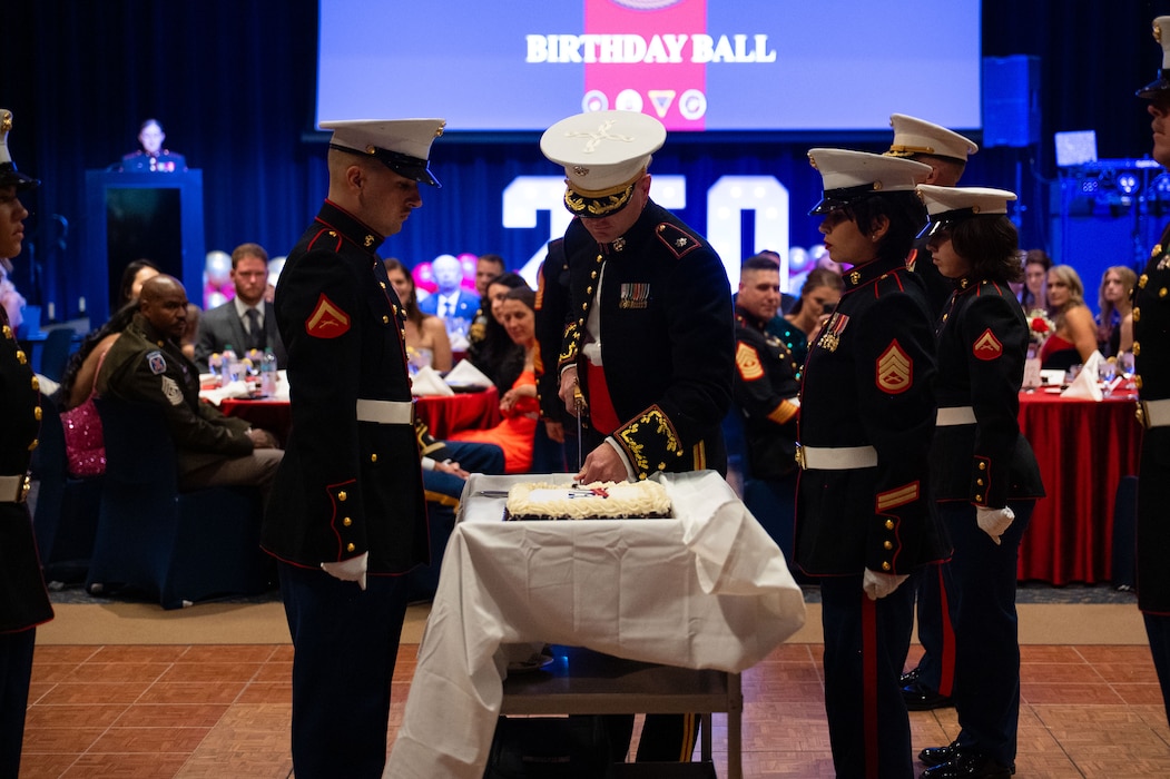 U.S. Marine Corps Lt. Col. Brian Meade, Marine Corps Detachment Goodfellow commanding officer, cuts the birthday cake during the 250th Marine Corps Ball at the CJ Davidson Conference Center in San Angelo, Texas, Nov. 22, 2025. The cake cutting ceremony commemorates the passing of wisdom from one generation of Marines to the next. (U.S. Air Force photo by Airman 1st Class Brian Lummus)