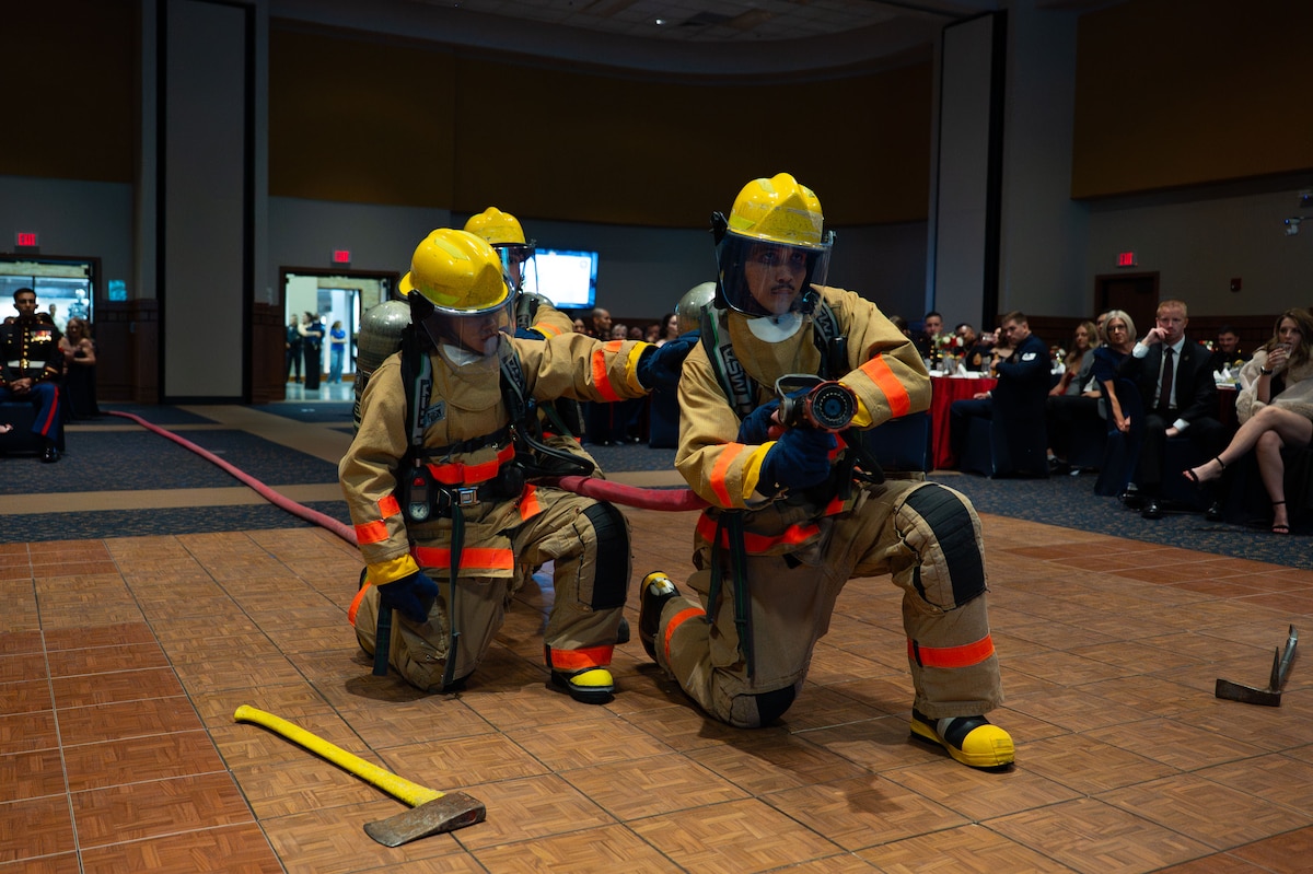 Students attached to Marines Corps Detachment Goodfellow display the equipment used at the Louis F. Garland Department of Defense Fire Academy during the 250th Marine Corps Ball at the CJ Davidson Conference Center in San Angelo, Texas, Nov. 22, 2025. Marine firefighters are trained in emergency medical response, fundamentals of firefighting, advanced firefighting operations, hazardous materials response and aircraft rescue and firefighting. (U.S. Air Force photo by Airman 1st Class Brian Lummus)