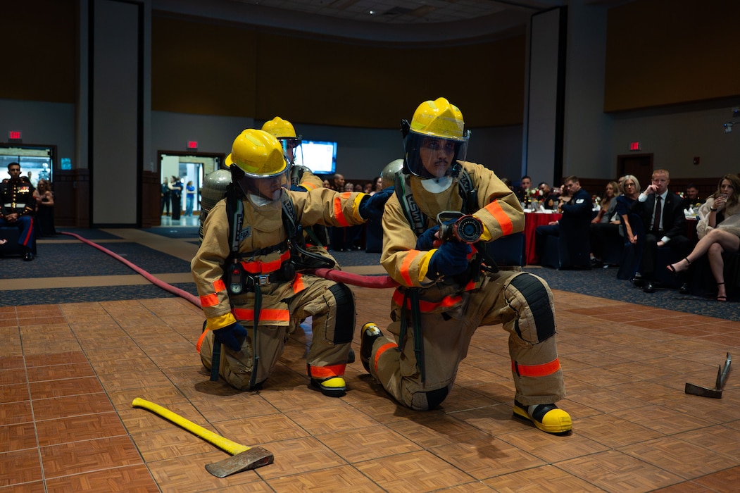 Students attached to Marines Corps Detachment Goodfellow display the equipment used at the Louis F. Garland Department of Defense Fire Academy during the 250th Marine Corps Ball at the CJ Davidson Conference Center in San Angelo, Texas, Nov. 22, 2025. Marine firefighters are trained in emergency medical response, fundamentals of firefighting, advanced firefighting operations, hazardous materials response and aircraft rescue and firefighting. (U.S. Air Force photo by Airman 1st Class Brian Lummus)