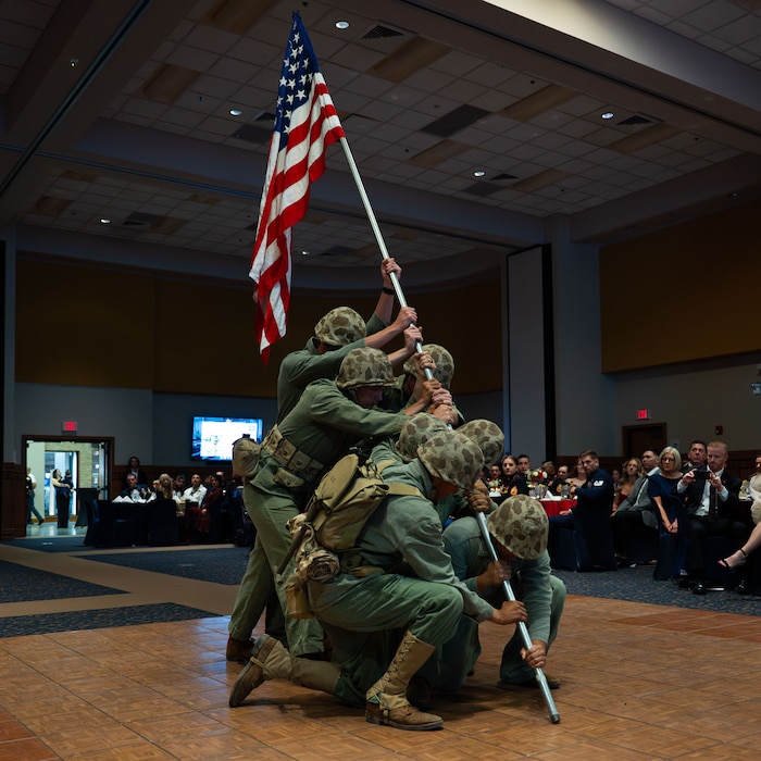 Students attached to Marines Corps Detachment Goodfellow reenact the raising of the U.S. Flag on Mount Suribachi during the 250th Marine Corps Ball at the CJ Davidson Conference Center in San Angelo, Texas, Nov. 22, 2025. The original photo by Joe Rosenthal is one of the most recognizable photos from World War II. (U.S. Air Force photo by Airman 1st Class Brian Lummus)