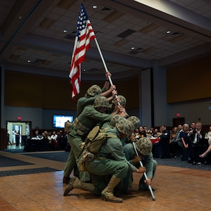Students attached to Marines Corps Detachment Goodfellow reenact the raising of the U.S. Flag on Mount Suribachi during the 250th Marine Corps Ball at the CJ Davidson Conference Center in San Angelo, Texas, Nov. 22, 2025. The original photo by Joe Rosenthal is one of the most recognizable photos from World War II. (U.S. Air Force photo by Airman 1st Class Brian Lummus)