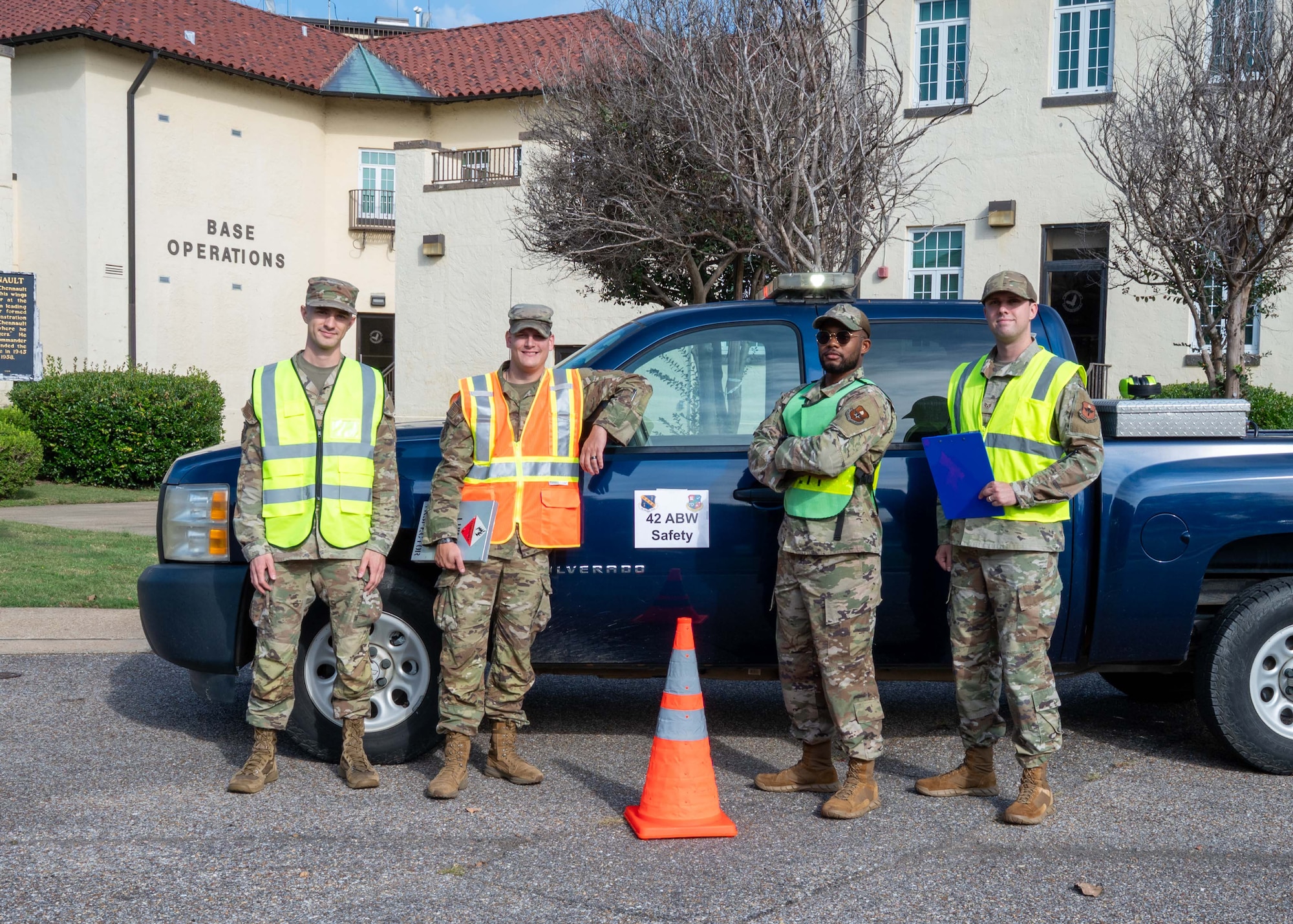 U.S. Air Force Staff Sgt. Daniel Miller, left, Staff Sgt. John Norris, Staff Sgt. Brennan Lukas, Staff Sgt. Daniel Miller, 42d Safety Office occupational safety technicians, pose for a photo in front of the safety truck at Maxwell Air Force Base, Oct. 9, 2025.