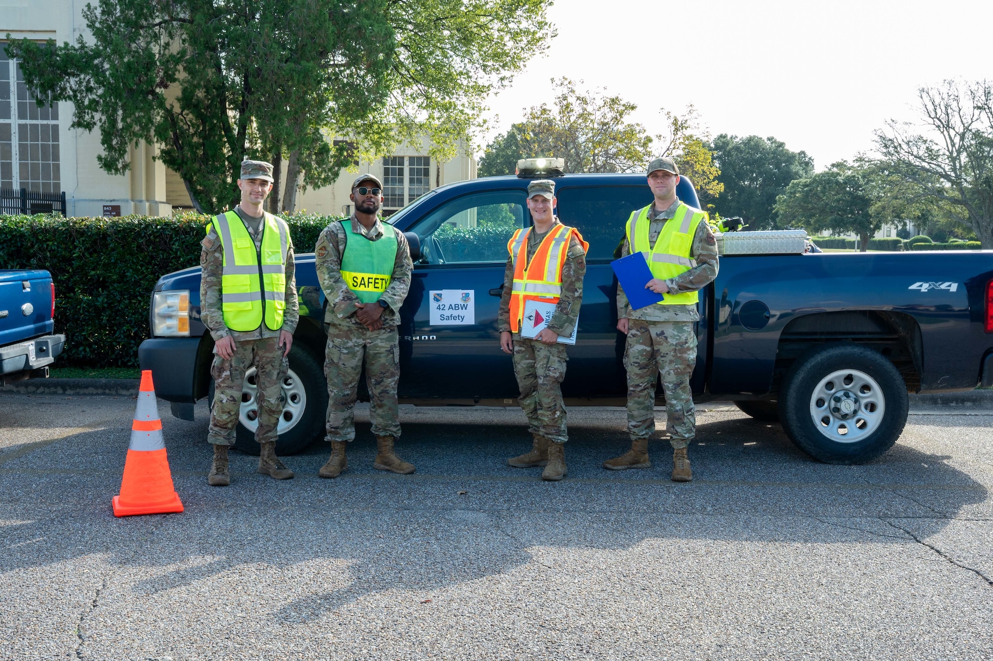 U.S. Air Force Staff Sgt. Daniel Miller, left, Staff Sgt. John Norris, Staff Sgt. Brennan Lukas, Staff Sgt. Daniel Miller, 42d Safety Office occupational safety technicians, pose for a photo in front of the safety truck at Maxwell Air Force Base, Oct. 9, 2025.