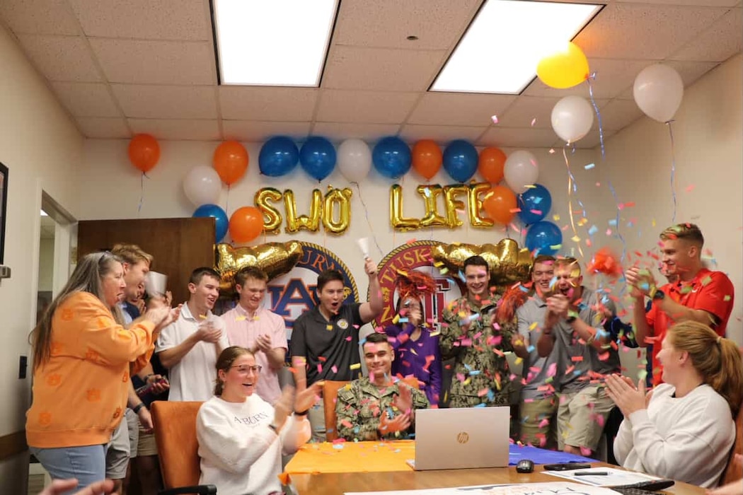 A midshipman celebrates with his peers after selecting his first ship assignment during the bi-annual ship selection event coordinated by Navy Personnel Command PERS-41 SWO Assignments. Naval Reserve Officers' Training Corps (NROTC) is under the charge of Naval Service Training Command (NSTC), which oversees 98 percent of the Navy’s officer and enlisted accessions. NSTC, headquartered at Naval Station Great Lakes, Illinois, is the Foundry of America’s Fighting Force. NSTC transforms America’s sons and daughters into service professionals through Recruit Training Command, Officer Training Command Newport, and NROTC. Additionally, NSTC leads the Navy Junior ROTC citizenship development program, which instills leadership, character, and civic responsibility in high school students globally.